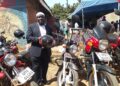 Goma Division Chairperson Hussein Ddumba Kato poses for a photo with one of the newly acquired motorcycles during the handover ceremony at the sacco offices in Mukono Municipality.