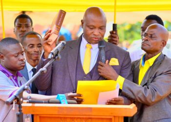 Francis Lukooya Mukoome takes oath during his swearing-in ceremony as Mukono District LC5 Chairperson, marking the official start of his new term in office.