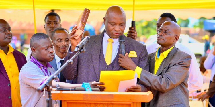 Francis Lukooya Mukoome takes oath during his swearing-in ceremony as Mukono District LC5 Chairperson, marking the official start of his new term in office.
