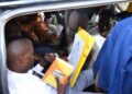 The late councillor-elect Henery Nagwano Kitata struggles to recite the oath of office from inside a vehicle moments before collapsing during the swearing-in ceremony at Nakisunga playground in Mukono District.