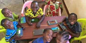 Learners using tablets during a classroom activity, part of the growing integration of digital learning tools in early childhood education.