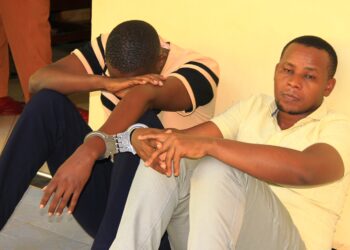 Mugabe Festo hiding his Face and Karamuzi Nathan at Masaka court