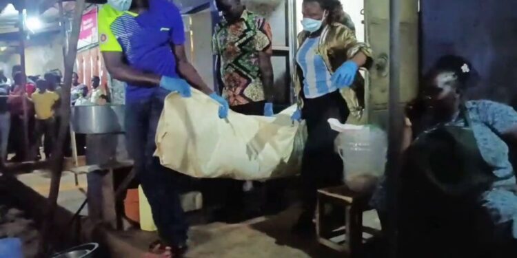 Police officers from Mukono District carry the body of Tikeni Sepela from a restaurant in Wantoni following his sudden deat