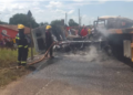 Firefighters work to extinguish flames after two cargo trucks burst into fire following a head-on collision.