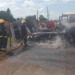 Firefighters work to extinguish flames after two cargo trucks burst into fire following a head-on collision.