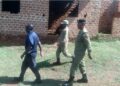 Police officers at Kitonzi Demonstration Nursery and Primary School during an operation targeting unlicensed schools.