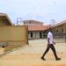 Students of St Kizito Technical Institute Kitovu walking past the new workshop built by government
