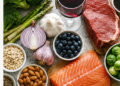 A selection of foods including salmon, garlic, broccoli, asparagus, berries and red meat, pictured in relation to research on how diet can influence natural body odour and perceived attractiveness.