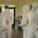 Health workers in protective gear during an Ebola response operation.