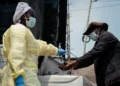 Visitors and patients wash their hands and undergo temperature checks before entering Kyeshero Hospital in Goma.