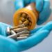 Herbal alternative medicine in capsules in prescription hospital bottle in doctor hand. Organic herb drug for natural treatment