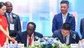 Prof. John Ddumba Ssentamu – Executive Chairman, Centenary Group and Paul Houpeiyong – Account Director Huawei Uganda sign the MOU as other Executive Members of both Centenary Group and Huawei look on..jp