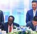 Prof. John Ddumba Ssentamu – Executive Chairman, Centenary Group and Paul Houpeiyong – Account Director Huawei Uganda sign the MOU as other Executive Members of both Centenary Group and Huawei look on..jp