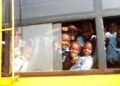 Children boarding a school bus during the morning commute.