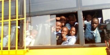 Children boarding a school bus during the morning commute.