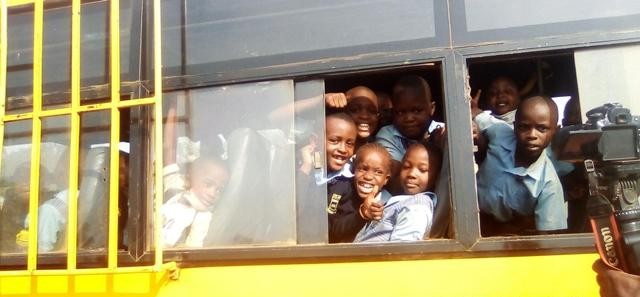 Children boarding a school bus during the morning commute.