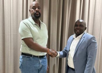 Patriotic League of Uganda (PLU) Chairman Muhoozi Kainerugaba shakes hands with newly appointed Secretary General Fadil Twallah