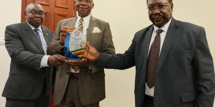 Left to right: Constitutional Court/Court of Appeal Justices Geoffrey Kiryabwire and Eldad Mwangusya Egonda-Ntende, together with Supreme Court Justice Christopher Izama Madrama, pose for a photograph during the presentation of an appreciation award.
