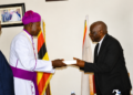 Incoming IRCU Chairperson Rt. Rev. Dr. Joseph Antony Zziwa (left) receives instruments of office from outgoing Chairperson Archbishop Stephen Samuel Kaziimba Mugalu