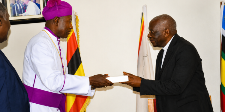 Incoming IRCU Chairperson Rt. Rev. Dr. Joseph Antony Zziwa (left) receives instruments of office from outgoing Chairperson Archbishop Stephen Samuel Kaziimba Mugalu