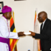 Incoming IRCU Chairperson Rt. Rev. Dr. Joseph Antony Zziwa (left) receives instruments of office from outgoing Chairperson Archbishop Stephen Samuel Kaziimba Mugalu