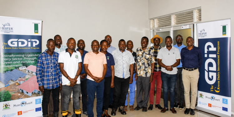Agricultural extension workers and veterinary officers pose for a group photo during the launch of a dairy development programme in Masaka that will support 7,000 livestock farmers with modern farming practices.