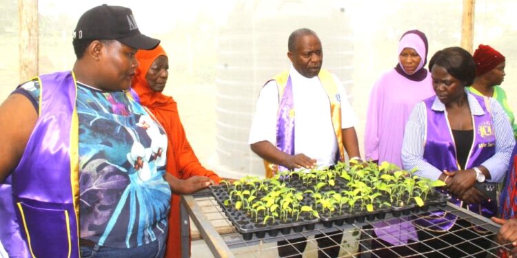 Members of the Lions Club of Masaka and Lions Club of Masaka Greater inspect community projects at Kyabumba Primary School in Masaka District ahead of their joint leadership handover ceremony.