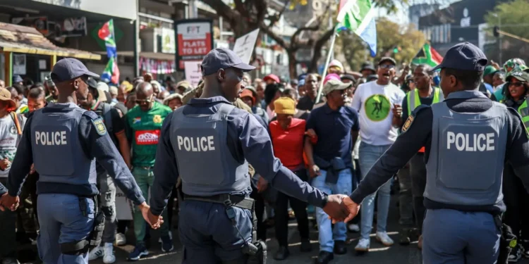 Heavy security personnel monitor coordinated anti-migrant protests taking place across South Africa, as demonstrators march in cities nationwide.