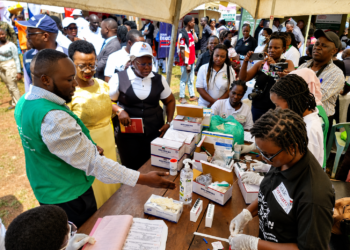 Minister of State for Health (General Duties), Anifa Kawooya Bangirana, inspects a sickle cell screening and testing station during the Self Care Awareness Day celebrations in Lugazi Municipality, Buikwe District