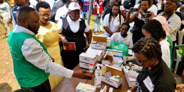 Minister of State for Health (General Duties), Anifa Kawooya Bangirana, inspects a sickle cell screening and testing station during the Self Care Awareness Day celebrations in Lugazi Municipality, Buikwe District