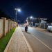 Pedestrians and motorists use a newly reconstructed, solar street lit road and paved walkway in Mukono Municipality at night. The upgraded infrastructure is intended to improve road safety, mobility, and accessibility for both motorists and pedestrians.