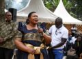 Minister for the Presidency Milly Babalanda addresses mourners during the burial of former Bank of Uganda Deputy Governor Perezi Tenywa Bukhumune