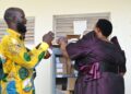 Minister for the Presidency Hon. Babirye Milly Babalanda hands over science kits to Buyende District officials during the commissioning ceremony for government schools.