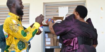 Minister for the Presidency Hon. Babirye Milly Babalanda hands over science kits to Buyende District officials during the commissioning ceremony for government schools.