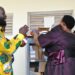 Minister for the Presidency Hon. Babirye Milly Babalanda hands over science kits to Buyende District officials during the commissioning ceremony for government schools.