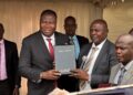 The Rt Hon Speaker of Uganda Jacob Markson Oboth receiving a bible from Pastor Samuel Lwandasa during Prayer and Thanksgiving Ceremony organized by Greater Mukono Inter Faith Forum.