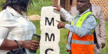 Christopher Mutumba, a law enforcement officer in Mukono Municipality’s Physical Planning Department, shows one of the boundary markstones installed during the municipal boundary-marking exercise.
