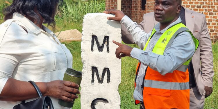 Christopher Mutumba, a law enforcement officer in Mukono Municipality’s Physical Planning Department, shows one of the boundary markstones installed during the municipal boundary-marking exercise.
