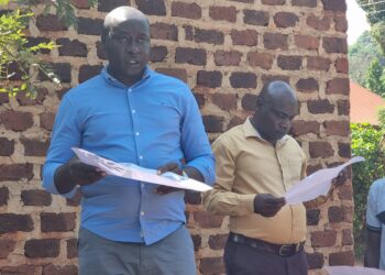 Mukono Town Planner, Hillary Murungi explains the land acquisition transactions to councillors.