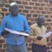 Mukono Town Planner, Hillary Murungi explains the land acquisition transactions to councillors.