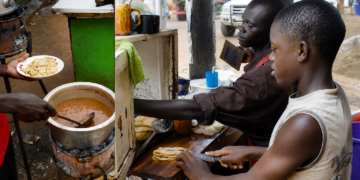 A food vendor operating close to a road or walkway.