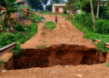 A section of a road in Njeru Municipality left severely damaged after a deep section of the road collapsed, disrupting access for residents.