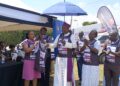 Eurofoam Marketing Manager Claire Kemigisha buys the first jersey from Mukono Diocese Bishop Enos Kagodo to launch the Mukono Cathedral Run