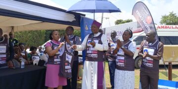 Eurofoam Marketing Manager Claire Kemigisha buys the first jersey from Mukono Diocese Bishop Enos Kagodo to launch the Mukono Cathedral Run