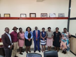 Mukono Municipal officials and representatives from Water For People pose for a group photo after a meeting at the Town Clerk’s office to discuss plans for improving sanitation facilities at Lweza Primary School.