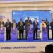 Minister David Bahati (3rd left) posing for a photo with the Stanbic Uganda team led by the Bank's Chief Executive Mumba Kalifungwa(centre) after the launch