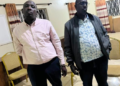 Sembabule District Land Board Secretary Michael Kakuru (in jacket) and Emmanuel Kananura, the Senior Land Management Officer, after their arrest on Thursday over allegations linked to corruption and abuse of office.