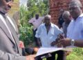 Njeru Municipality Deputy RDC Richard Kakwezi and Njeru Municipality Planner Edmond Musoke at Kilyowa Village in Njeru Municipality Buikwe District.