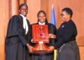 The winning UCU team receives the award from Minister for ICT and National Guidance Justine Kasule Lumumba after the final of the Unwanted Witness Privacy Moot Court Competition.