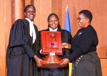 The winning UCU team receives the award from Minister for ICT and National Guidance Justine Kasule Lumumba after the final of the Unwanted Witness Privacy Moot Court Competition.